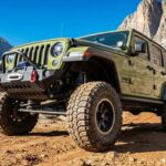 Your Jeep Wrangler tackling rugged terrain, showcasing the must-have upgrades for ultimate trail performance and safety.
